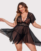 Black plus size babydoll with floral lace, deep V-neck, and asymmetrical hem.