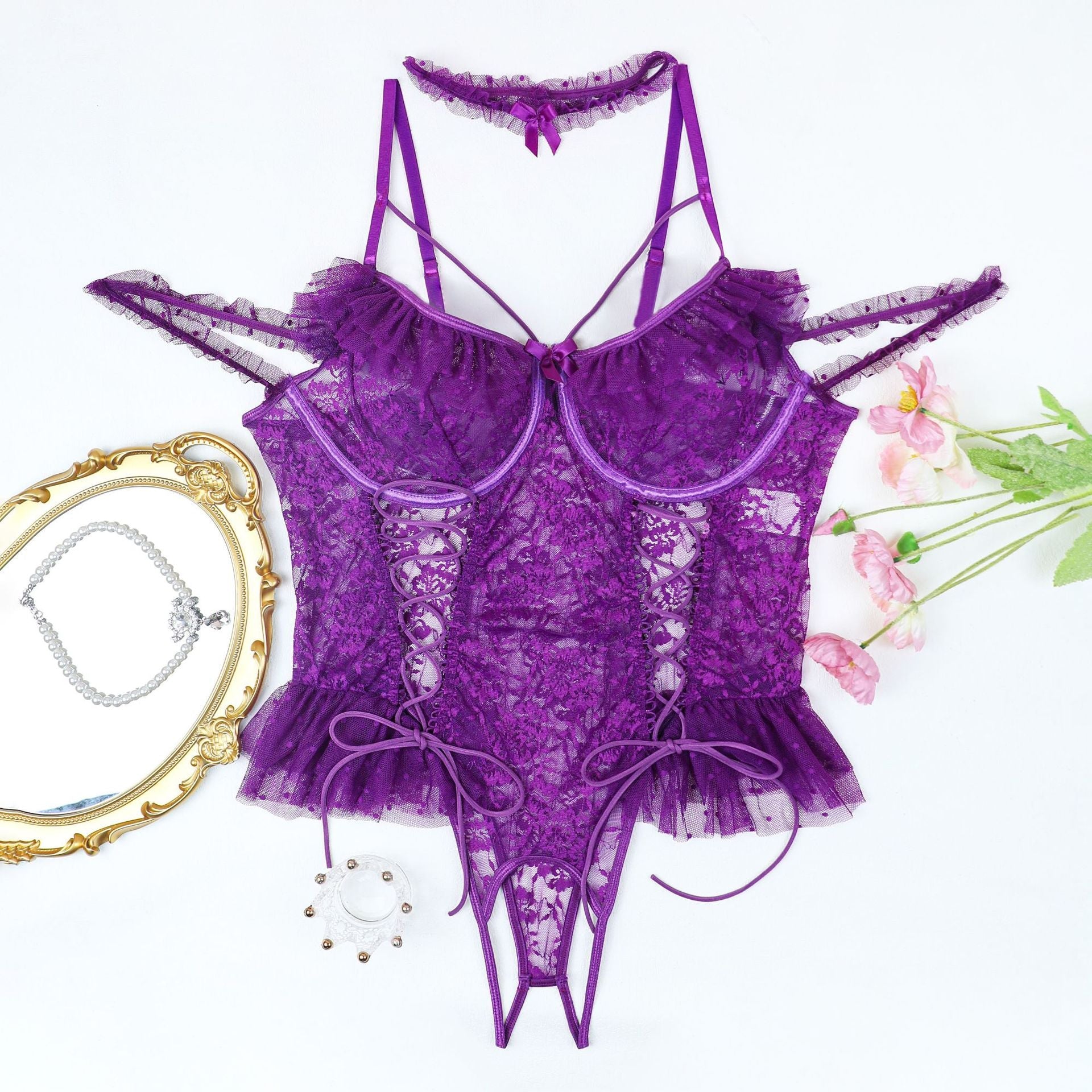Plus size purple lace bodysuit with adjustable straps, floral lace cups, and lace-up detail